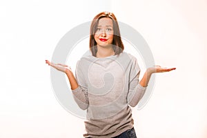 Brown hair beautiful helpless woman wearing grey shirt and jeans