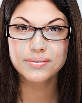 Brown hair, brown eyes, flawless face, bespectacled woman photo