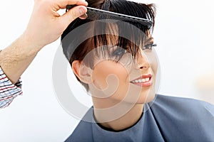 Brown Hair. Hairdresser doing Hairstyle. Beauty Model Woman. Haircut.