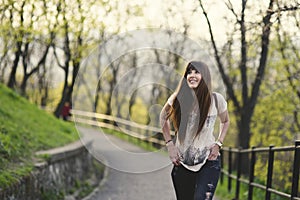 Brown hair young woman smiling in the park