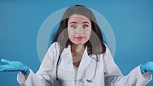 Brown-haired doctor with stethoscope looks around studio