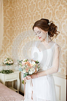 Brown-haired woman with classic wedding hair-style.