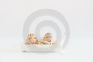 Brown hand drawn eggs with faces in the nest. Gift card for your design, place for text. Minimalist Easter