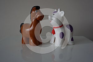 Brown horse and white lamb. Plastic figures.