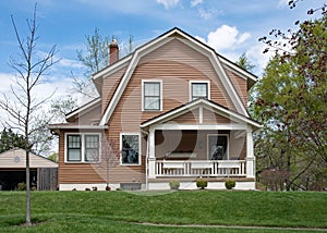 Brown House with Gambrel Roof in Springtime photo