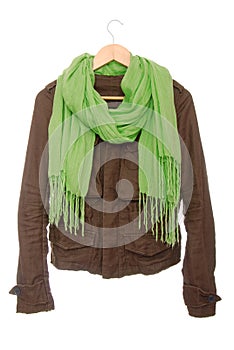 Brown jacket and green scarf are on hanger.