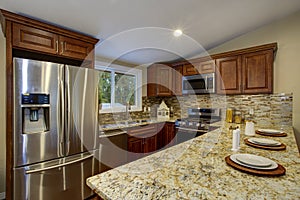 Brown kitchen design with mahogany kitchen cabinets.