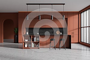 Brown kitchen interior with bar countertop and seats near panoramic window