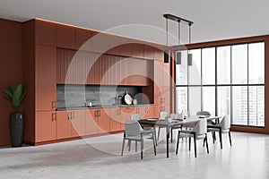 Brown kitchen interior with eating corner near panoramic window