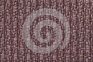 Brown knitted woolen background with a pattern of soft, fleecy cloth. Texture of textile closeup.