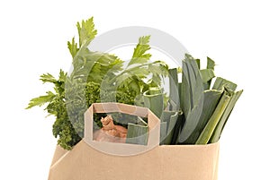 Brown kraft paper bag ful of vegetables