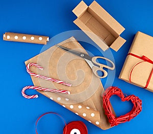 Brown kraft paper, packed gift bags and tied with a red ribbon, red heart