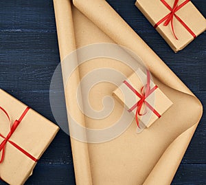 Brown kraft paper, packed gift boxes and tied with a red ribbon