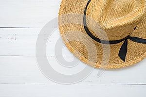 Brown lady hat on white wooden background with copy space, travel beach holiday ideas concept