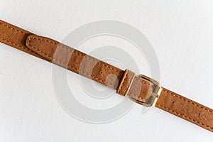 Brown leather belt with a buckle.