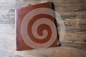 brown leather board on wooden background  Front Back Restaurant Menu Folder in Leather  empty mock up