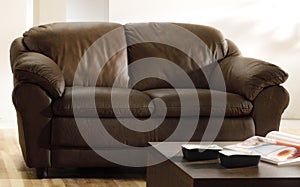 Brown leather couch and table photo