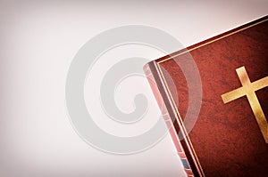 Brown leather cover of a Bible beside a table