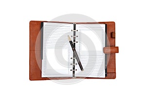 Brown leather journal with two empty polaroid frames and a brown-golden pen photo