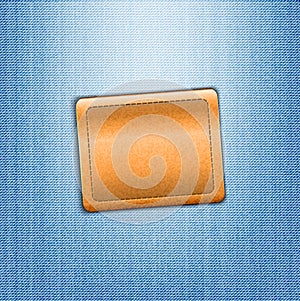 Brown leather label on blue jeans background