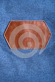 Brown leather label with stitching on denim. Copy space. Mockup