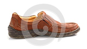 Brown leather men's shoes with wooden shoe stretchers on the sid.
