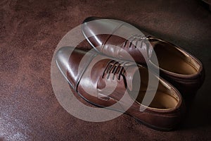 Brown leather men shoes on leather background