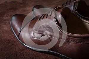 Brown leather men shoes on leather background