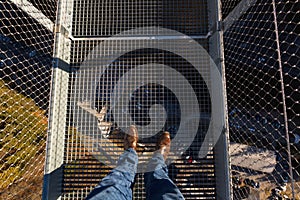 Brown leather shoes walking on Highline179 world`s longest suspe