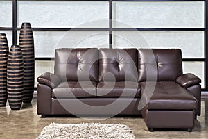 Brown leather sofa with stool