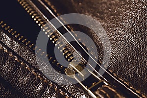 Brown leather texture and metal zipper . Fragment of leather jacket