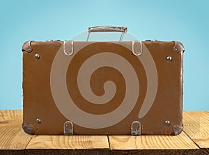 Brown leather vintage suitcase on background