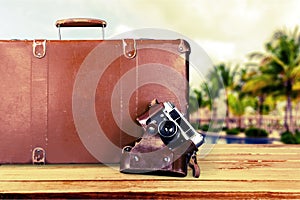 Brown leather vintage suitcase and camera