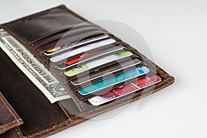 Brown leather wallet with credit cards and money