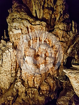 Brown limestone chalk stone formation light middle focus inside stalactive cave pai tour dark guided travel chiang mai