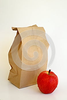 Brown lunch bag with red apple