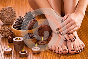 Brown manicure and pedicure on the white photo