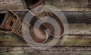 Brown men`s boots, on a wooden background