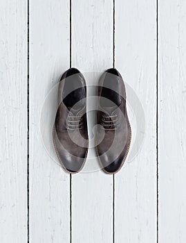 Brown men's shoes on a wooden background