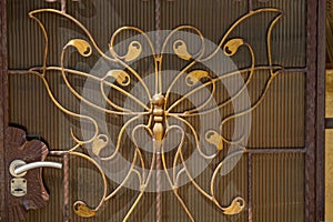 Brown metal texture in wrought iron butterfly pattern with door handle on the wall