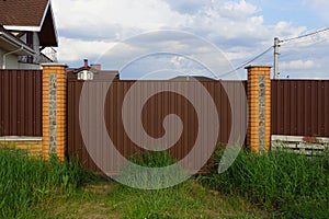 Brown metal gates and fence on the street