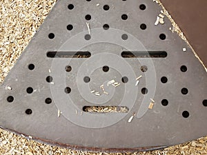 Brown metal step on play stucture that looks like a face