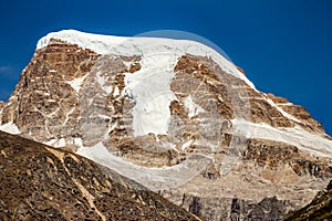 Brown mountain with snow on the top and yellow stone ground at Thangu and Chopta valley in winter in Lachen. North Sikkim, India