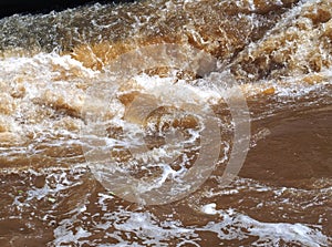 Brown muddy water of Erft river in a weir in Grevenbroich in Germany