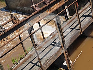 Brown muddy water of Erft river in a weir in Grevenbroich in Germany