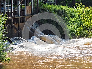 Brown muddy water of Erft river in a weir in Grevenbroich in Germany