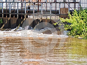 Brown muddy water of Erft river in a weir in Grevenbroich in Germany