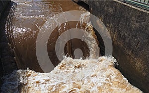 Brown muddy water of Erft river in a weir in Grevenbroich in Germany