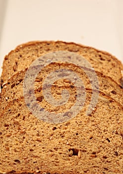 Brown multigrain bread slices on a white plate