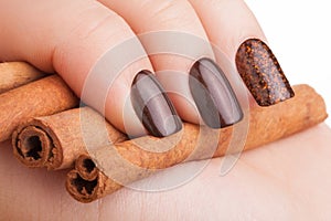 Brown nail polish on the nails.